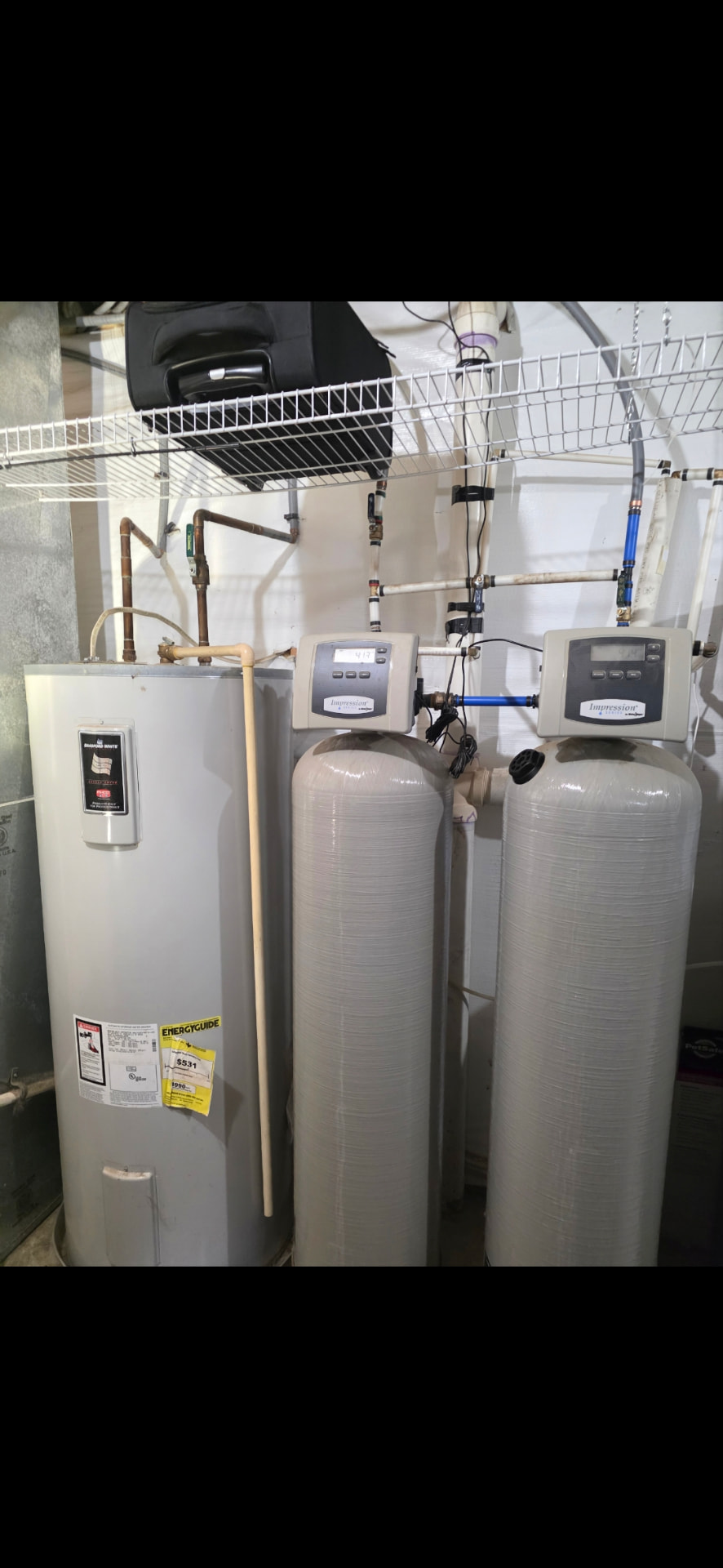 Bradford White water heater installed beside twin Impression filtration tanks