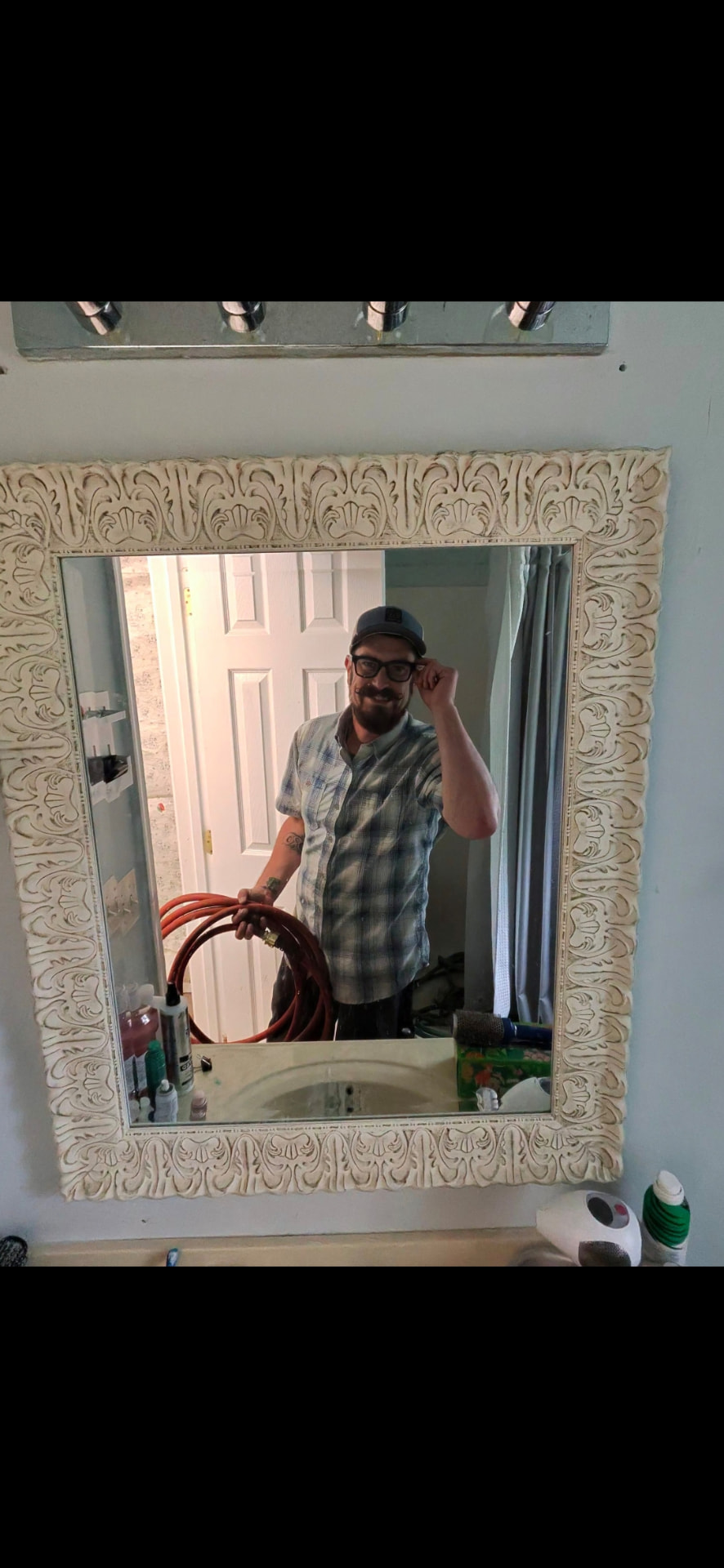 Ryan on a bathroom plumbing job with hose in hand