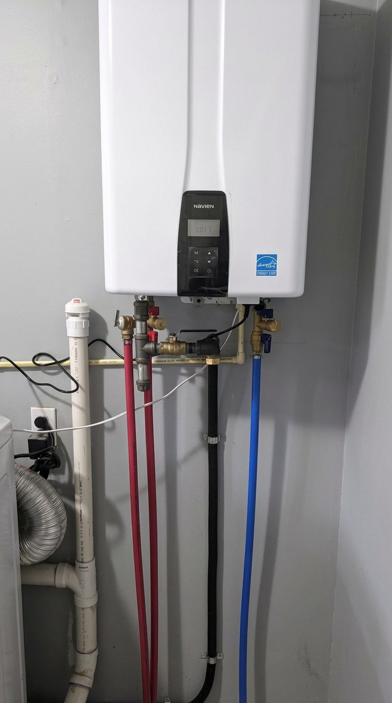 Interior Navien tankless water heater with connected water and gas lines